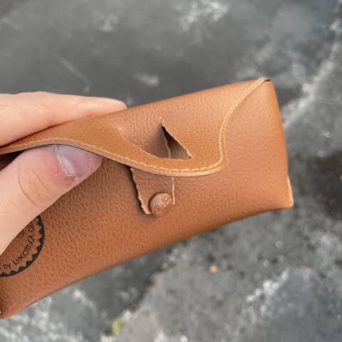 Cracked stock sunglasses case with a broken hinge