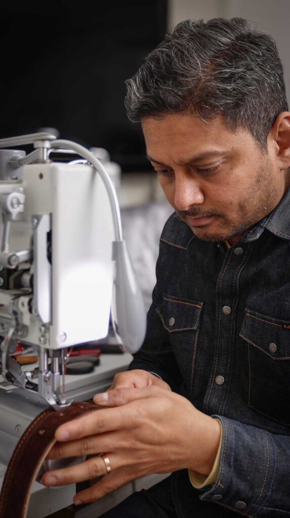 Mano stitching the belt